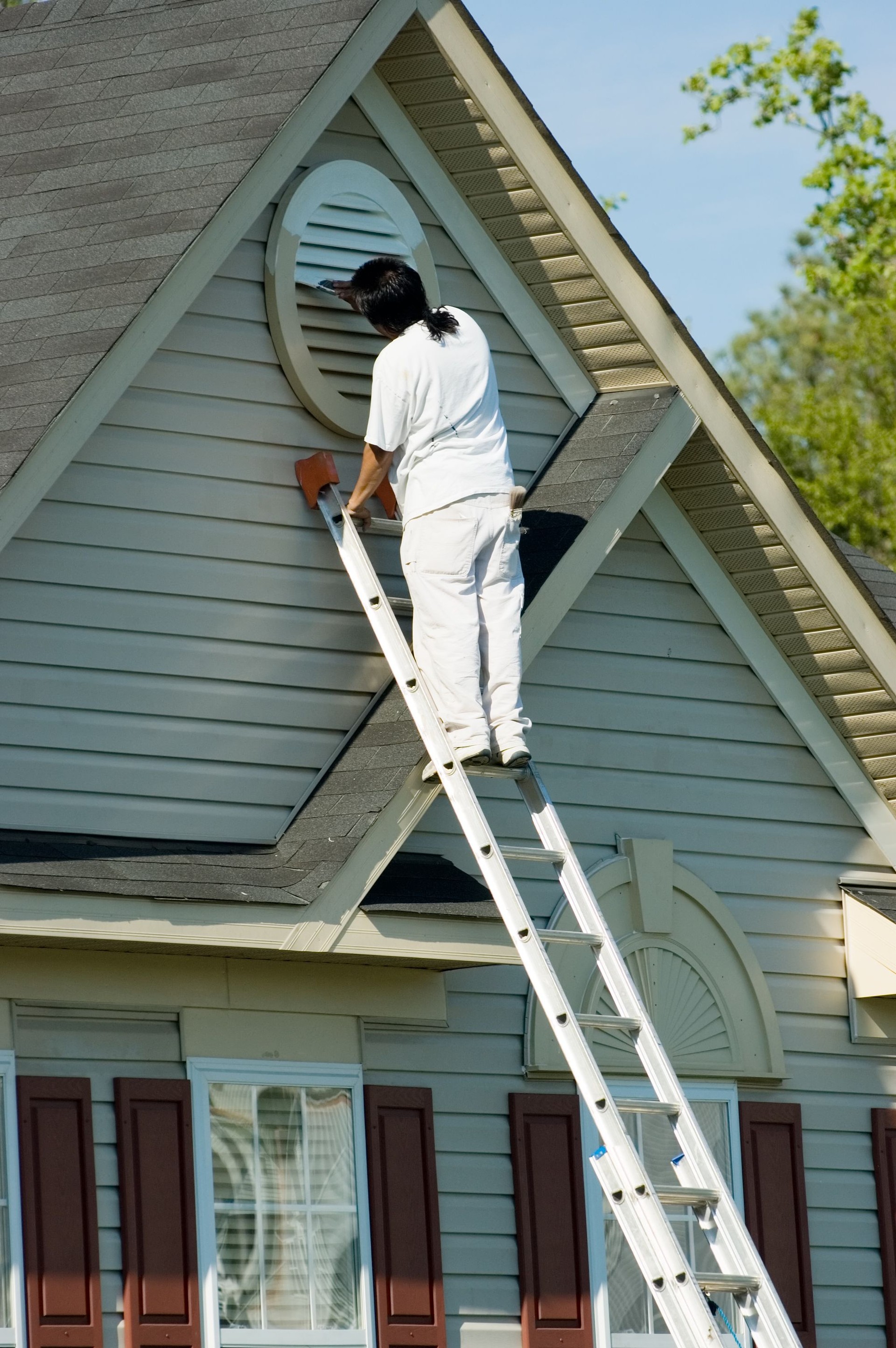 Painter Working at Roofline
